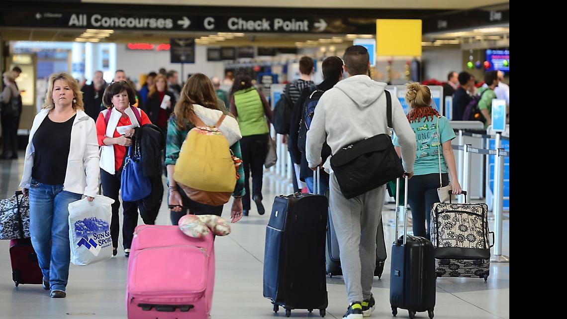 
In this 2014 Observer file photo, travelers make their way through Charlotte Douglas International Airport.

