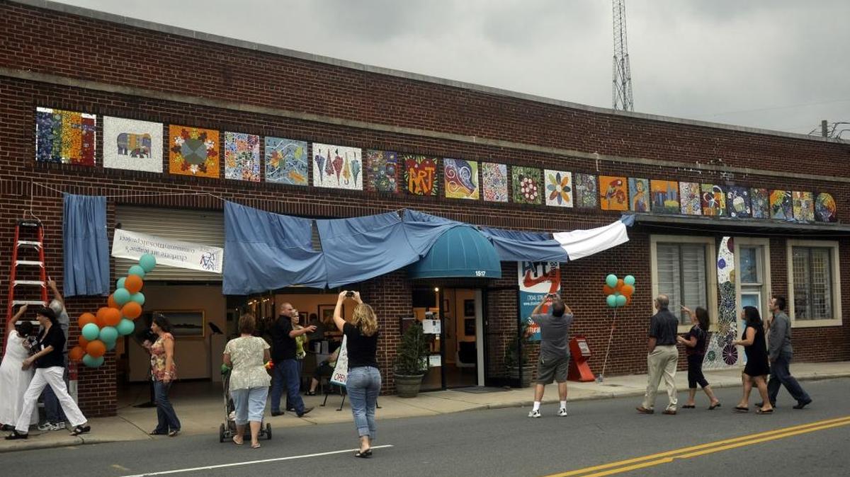 Onlookers get their first view of the community mosaic project as The Charlotte Arts League unveiled a community mosaic. Based on the Color Wheel, the all-volunteer project began in August of 2007.