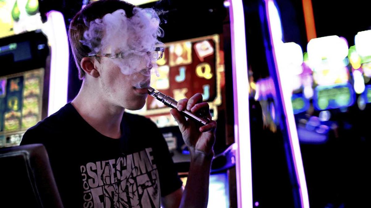In this 2014 file photo, a casino patron exhales vapor from an e-cigarette in Las Vegas.