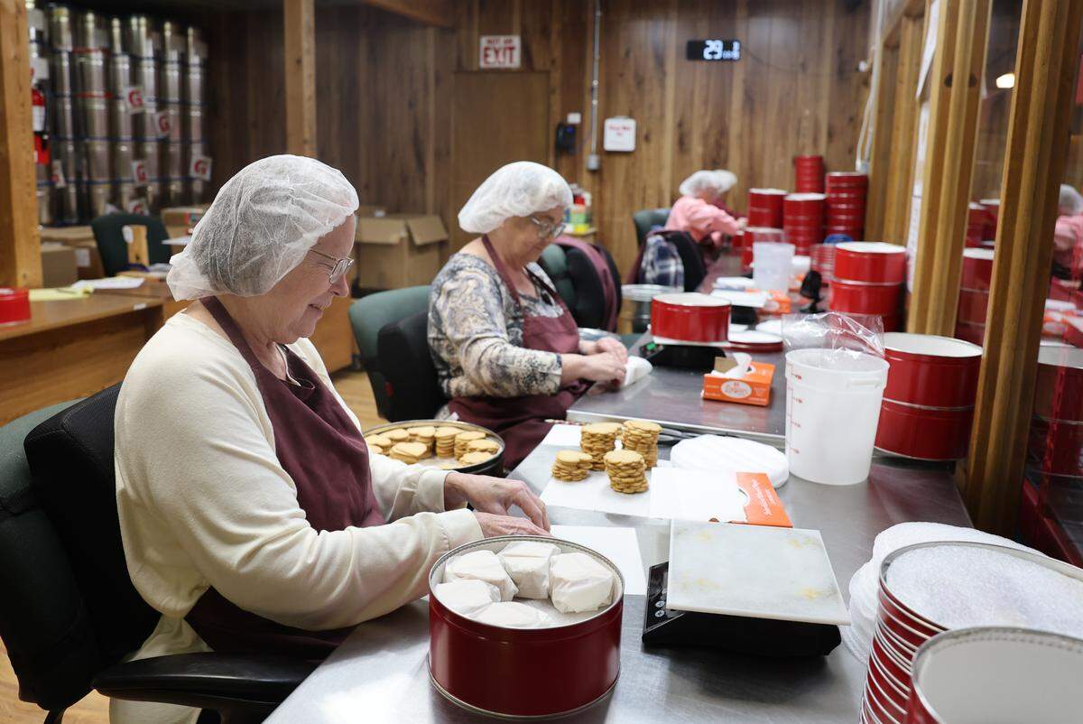 Workers hand-wrap cookies to ship Wednesday, Nov. 19, at Mrs. Hanes’ Moravian Cookies.