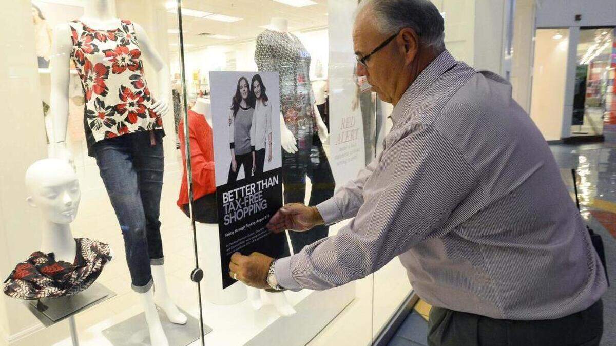 
Ray Soporowski, mall manager for Concord Mills, puts up a "better than tax-free shopping" sign on the front window of the Dressbarn at Concord Mills this week. The Dressbarn will participate in the upcoming "better than tax-free shopping" event Friday through Sunday.
