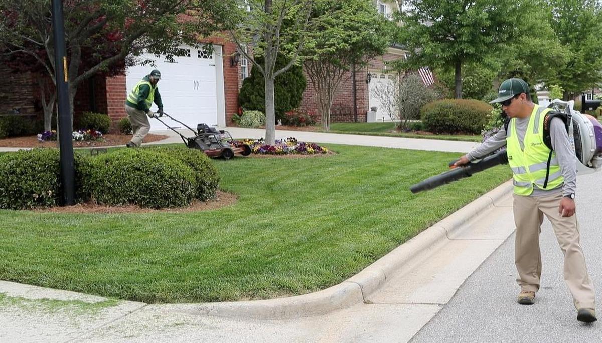 Luis Olivera, right, and Ruben Lugo, both from Mexico, work on the grounds of the DeVintage subdivision in Cary. They work for Greenscape Inc., a Raleigh landscaping company, under H-2B visas