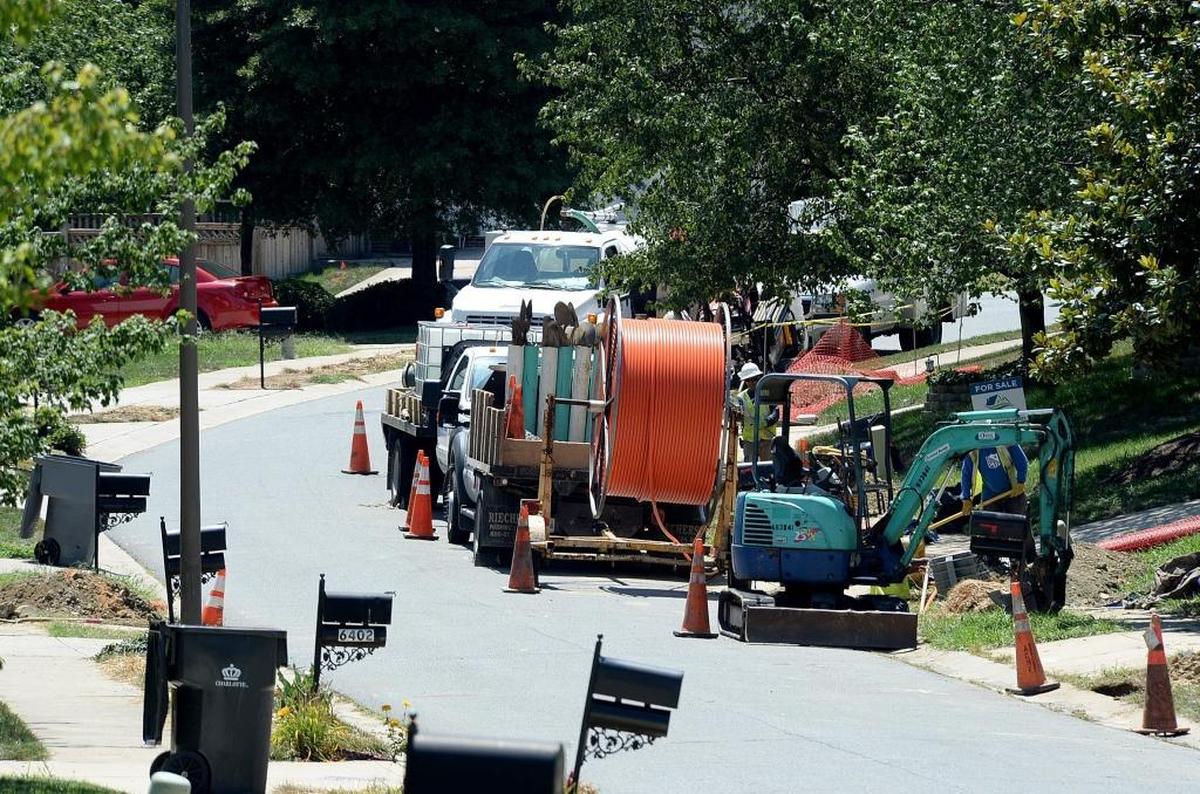 Contractors install fiber-optic cable lines in Charlotte in 2015, the year Google Fiber arrived to North Carolina. Following a multi-year pause, the internet provider has renewed expansion in the Triangle.