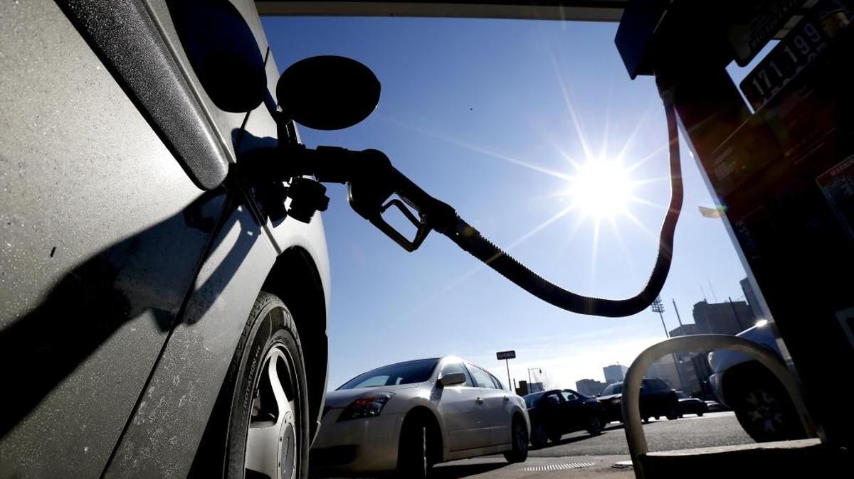
In this Jan. 23 file photo, vehicles form a line behind a motorist re-fueling at a gas station, in Newark, N.J. 

