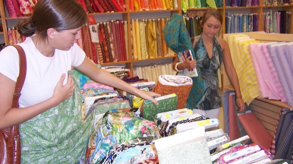 Bailey Peters, right, quickly decisive with her final choice while Lily Binner is still searching through the endless array of fabrics at Hancock Fabrics.