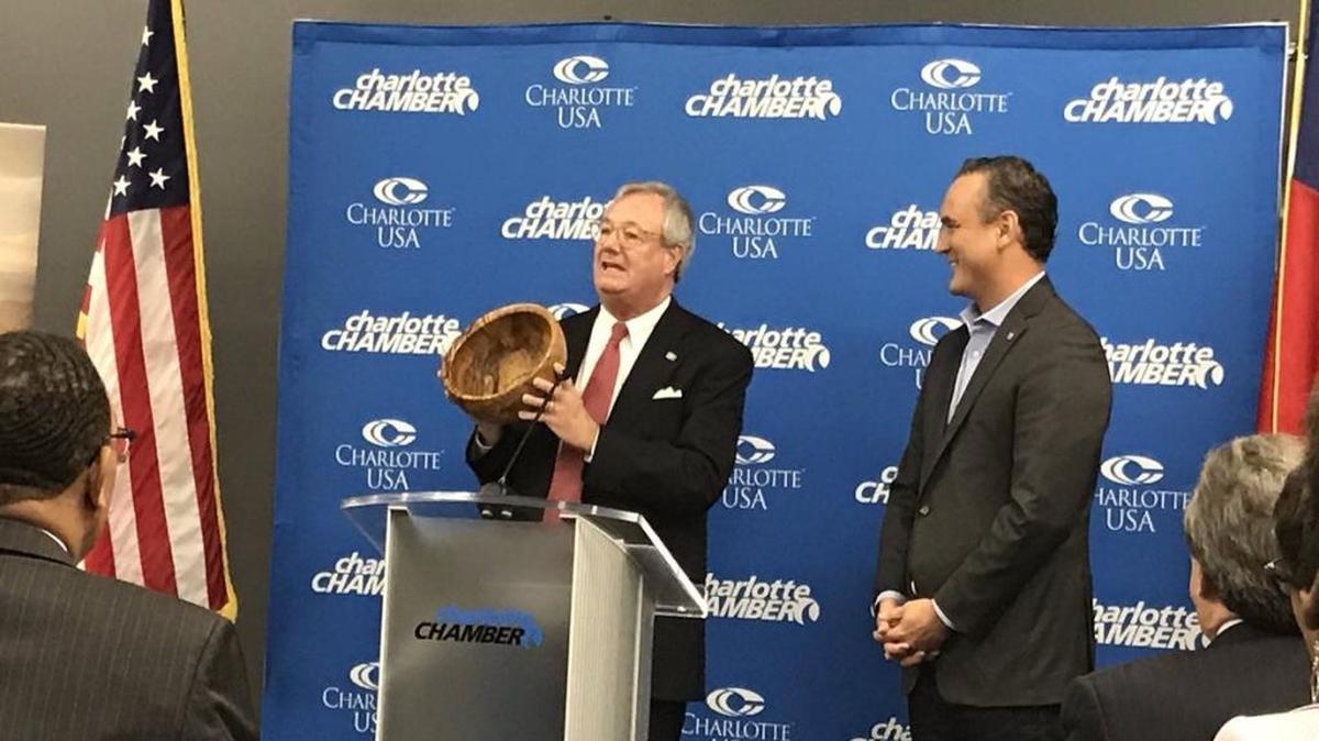 In this file photo, then-N.C. Commerce Secretary John Skvarla gives a wooden bowl to LendingTree CEO Doug Lebda after tthe company announced 314 new jobs. Katherine Peralta kperalta@charlotteobserver.com