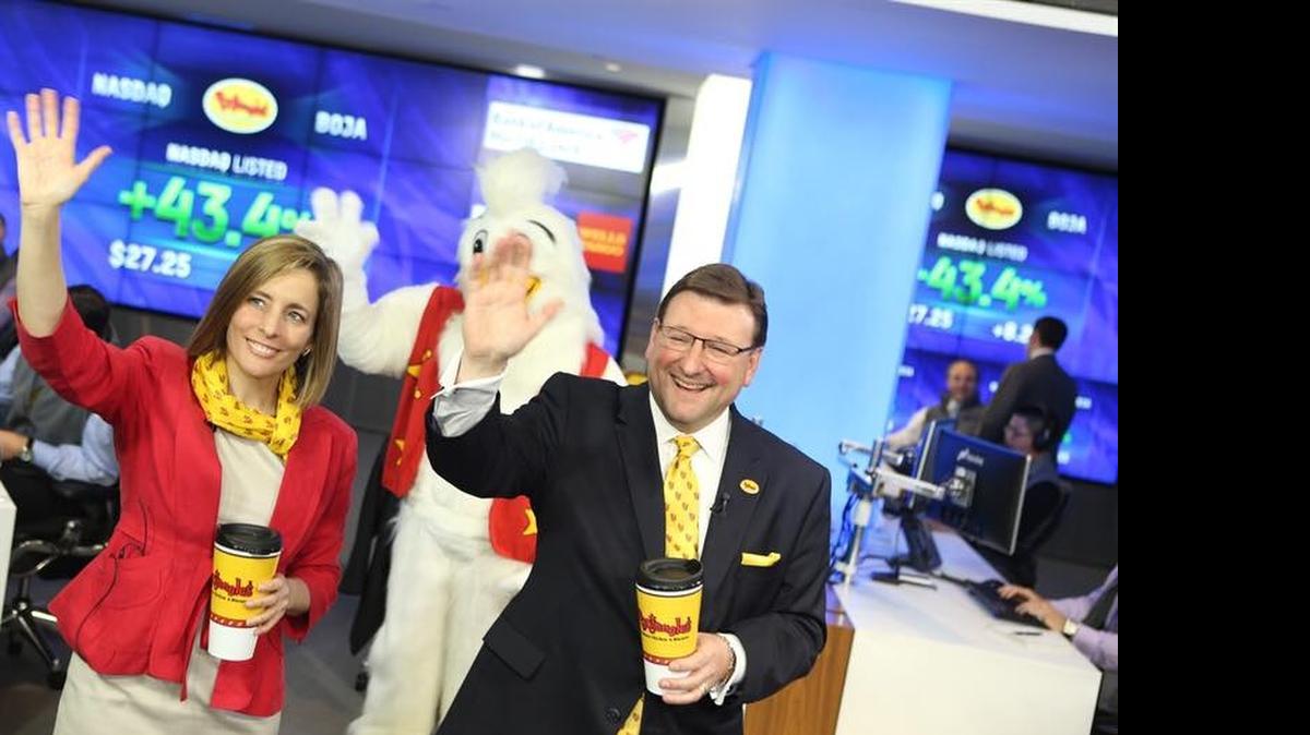 
Karin McKinnell, NASDAQ’s senior managing director of new listings, and Bojangles’ CEO Clifton Rutledge celebrate the fast food chain’s initial public stock offering on Friday.
