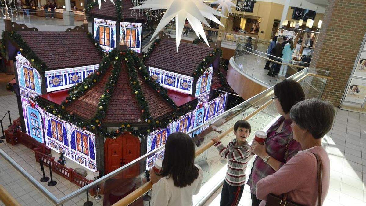 (L-R) Aubrie Goodman, 8, and her brother Jaxon Goodman, 6, came to Northlake Mall with their mother Megan Goodman and grandmother Terry Moore. The children enjoyed watching the display change on the "Ultimate Santa Adventure" at the mall.