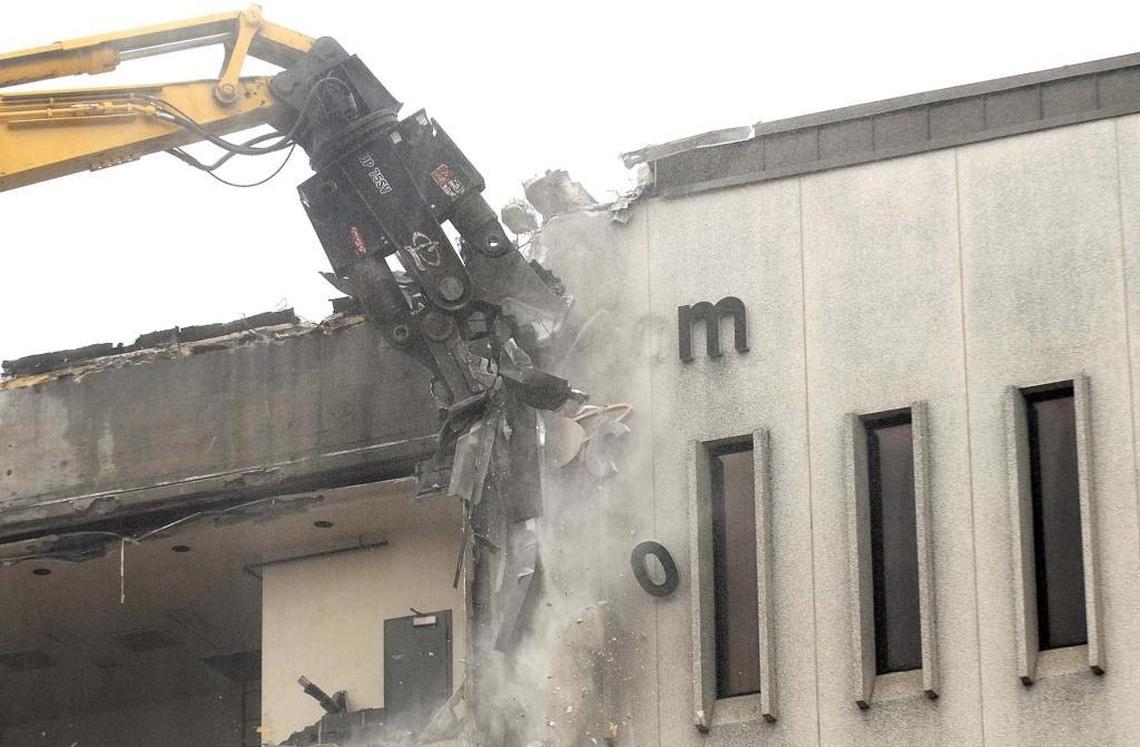 Lettering on the Observer's facade falls to the ground as demolition begins at 600 South Tryon St Monday, August 1, 2016.