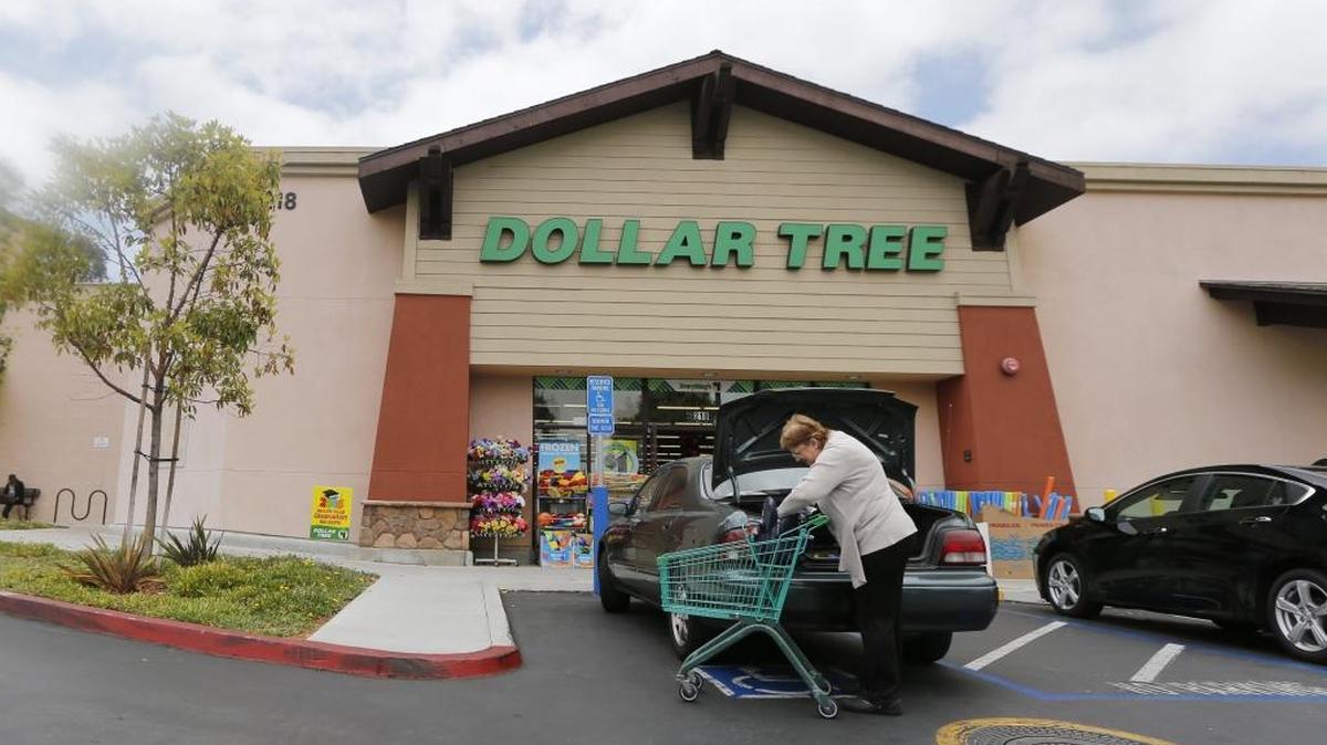 In this Thursday, May 26, 2016, file photo, a shopper searches her purse outside a Dollar Tree store in Encinitas, Calif. Dollar Tree, parent company of Matthews-based Family Dollar, named Gary Philbin its new CEO on Monday.
