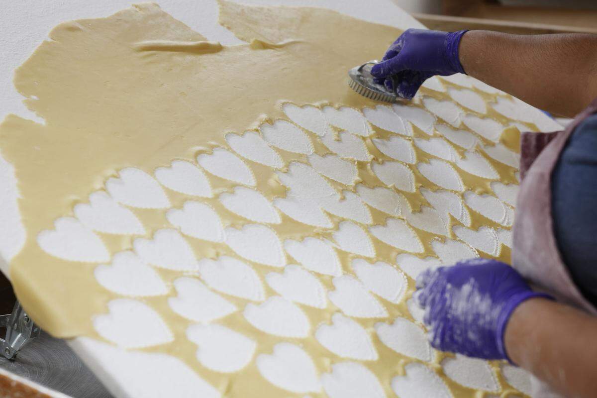 Lucy Azam cuts out cookies to bake Wednesday, Nov. 19 at Mrs. Hanes’ Moravian Cookies.