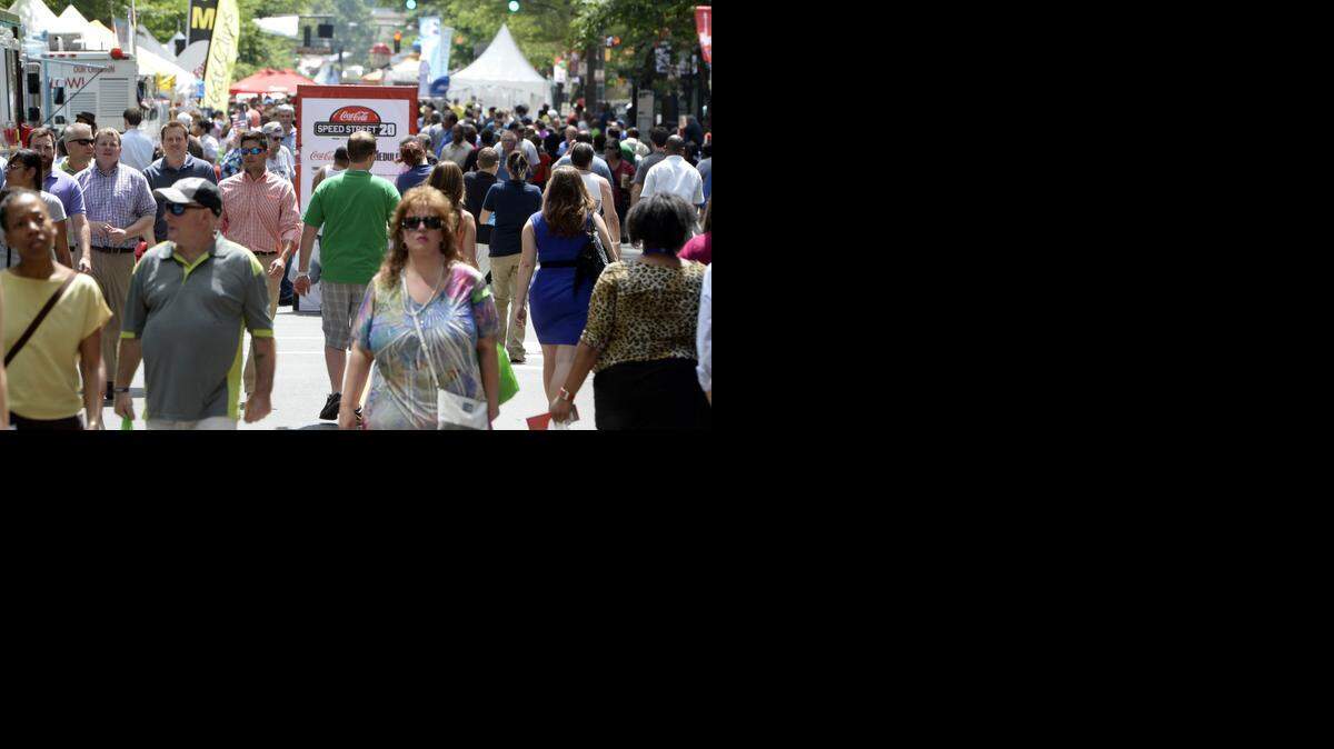 
Pedestrians walk along Tryon Street while attending Coca-Cola Speed Street on May 22, 2014. Circle K replaces Food Lion as the new sponsor, and company and event officials say the arrangement is currently a one-year partnership that could eventually turn into something longer term. 
