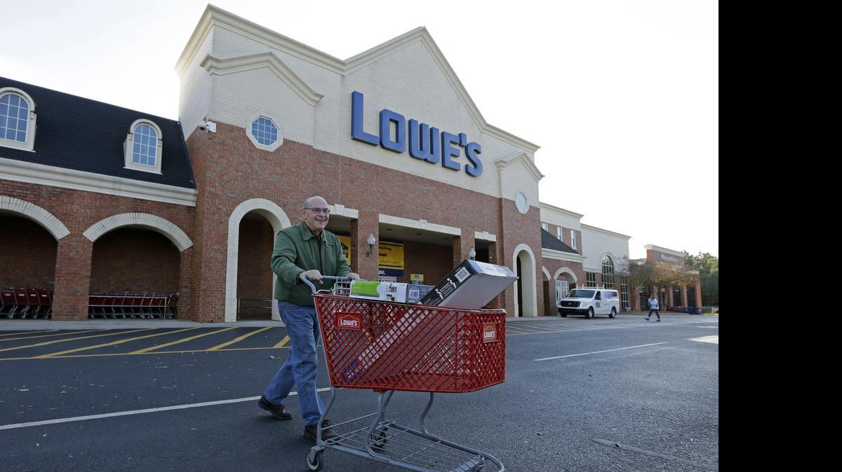 
A customer leaves a Lowe's home improvement store in Charlotte in November 2014. Lowe's reported first quarter sales and earnings Wednesday that were up from a year ago but that fell below Wall Street expectations. 
