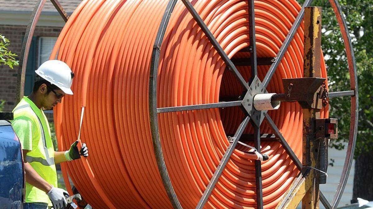 
Contractors install fiber optic cable lines for Google Fiber in Highland Creek. The work has brought its share of construction-related inconveniences to the neighborhood, some residents say.

