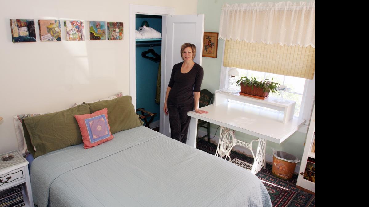 
Allyn Meredith stands in the room she rents out in Durham on the Airbnb online platform, in a photo from earlier this year. Meredith has been an Airbnb host since November 2011. Airbnb said this week it would begin collecting and remitting sales taxes in North Carolina beginning June 1. It will also collect hotel occupancy taxes in Mecklenburg, Wake, Durham and Buncombe counties from guests renting rooms. 
