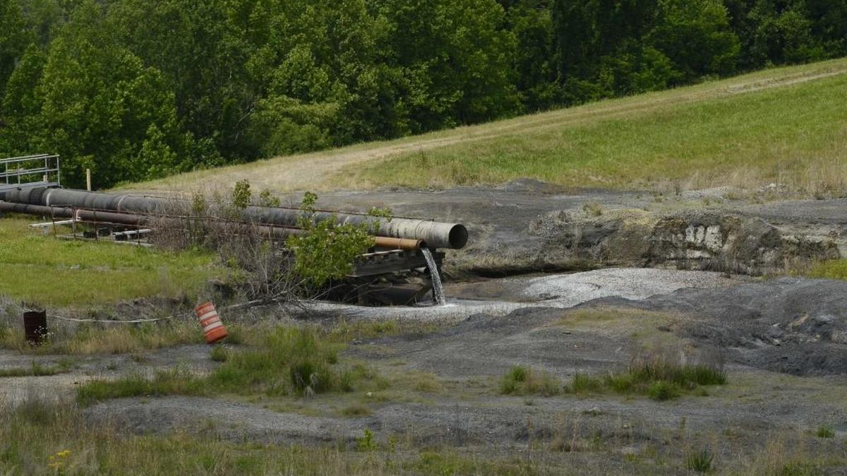 
An inlet pipe drains into an ash pond at Duke Energy’s retired Riverbend power plant in 2014.
