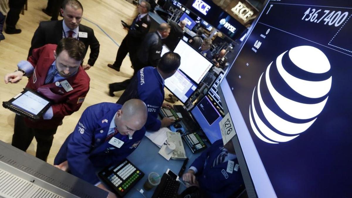 AT&T on Monday formally unveiled DirecTV Now, a live online video service for consumers, especially mobile-phone owners, who don’t want conventional pay-TV. In this file photo, traders gather at the post that handles AT&T on the floor of the New York Stock Exchange.