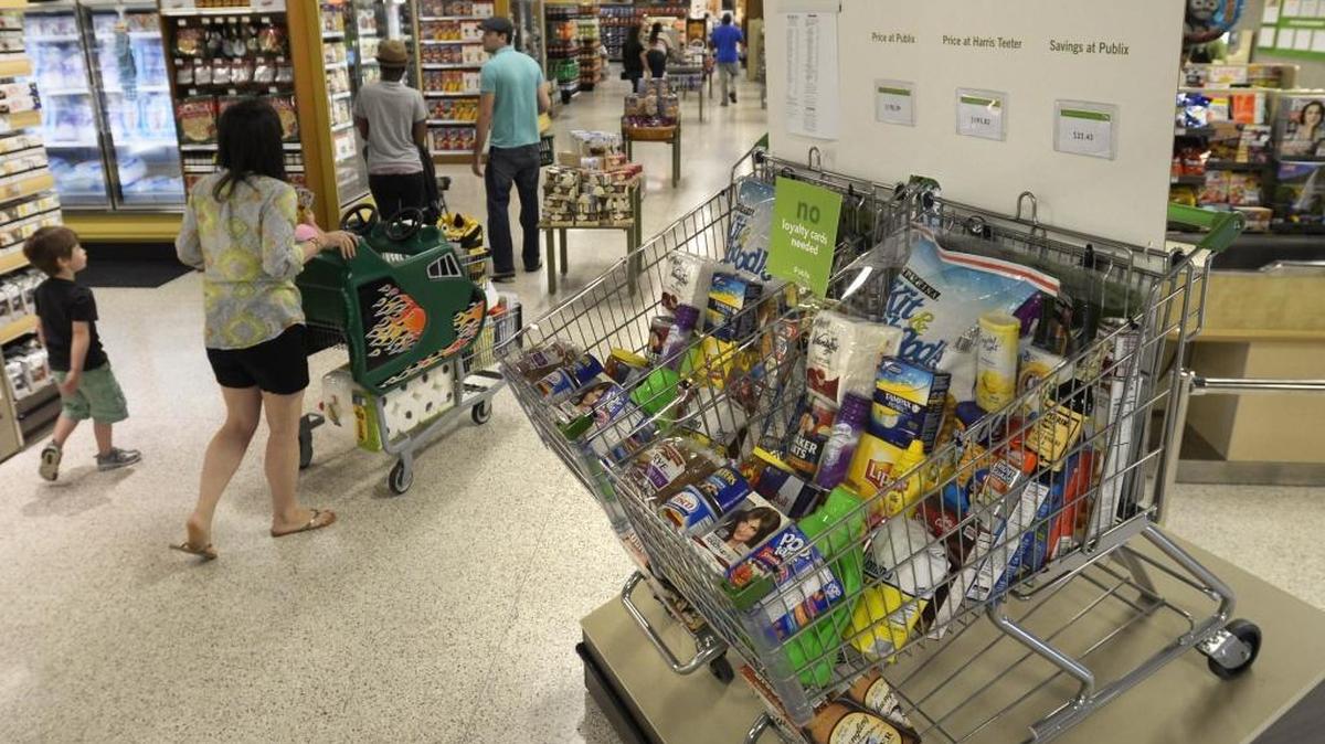 
Shoppers at the Publix store in Ballantyne pass by a new price comparison display in front of the store in a May 2014 file photo. Publix doesn’t offer home delivery or in-store pickup for online orders, but Birmingham, Ala.-based delivery company Shipt launched service in Charlotte in September with delivery from area Publix stores.
