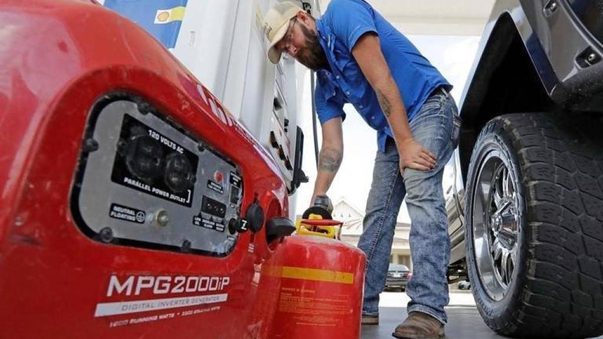 Aaron Berg fills up a gas can and his portable generator Thursday, Aug. 24, 2017, in Houston. Hurricane Harvey has hit a refinery-rich stretch of the Gulf Coast, and U.S. drivers nationwide are seeing the impact at the gas pump.