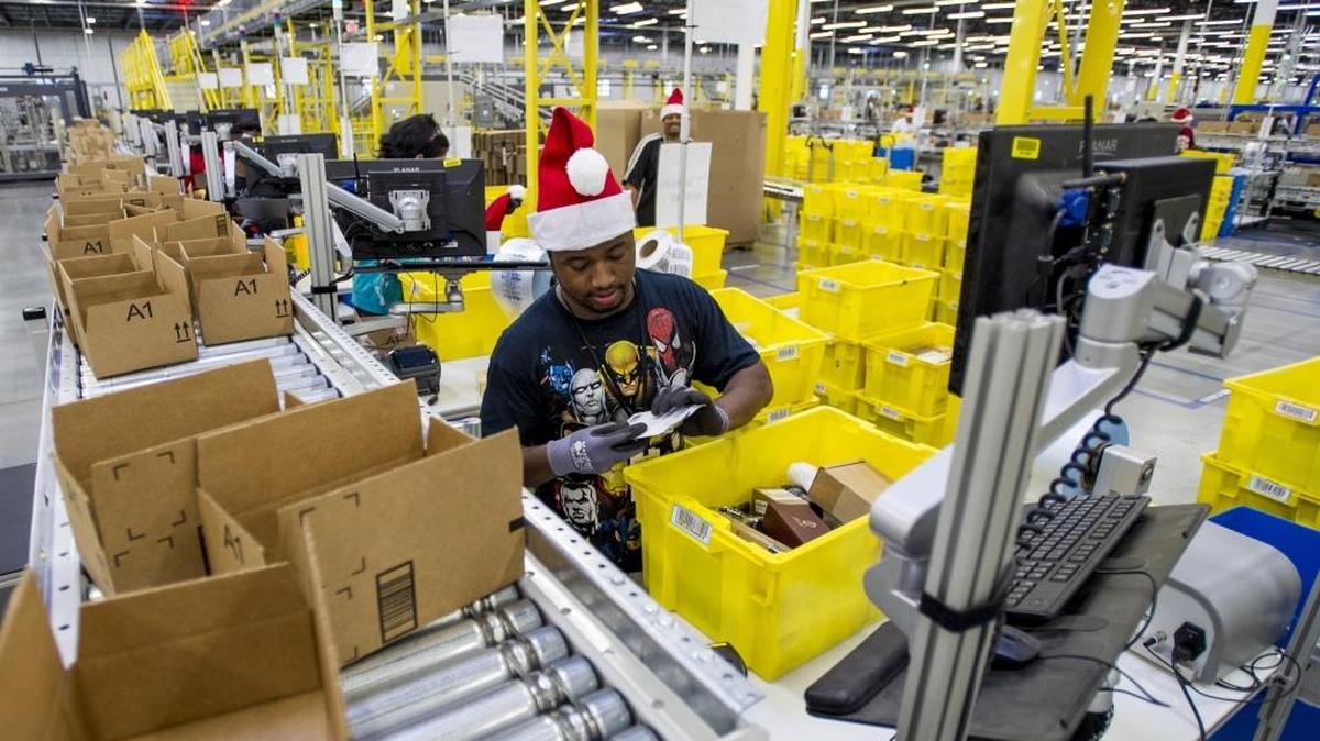 Amazon employees load boxes with orders at the company’s fulfillment center ahead of Cyber Monday in Tracy, Calif., on Nov. 30, 2014.