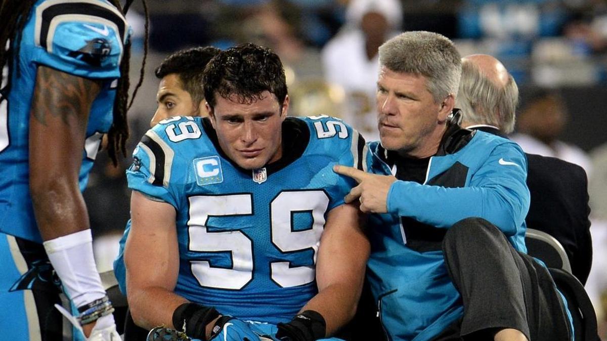 Carolina Panthers assistant athletic trainer Mark Shermansky, right, keeps a close eye on linebacker Luke Kuechly, left, as he is driven from the field after being injured on a play against the New Orleans Saints Thursday.