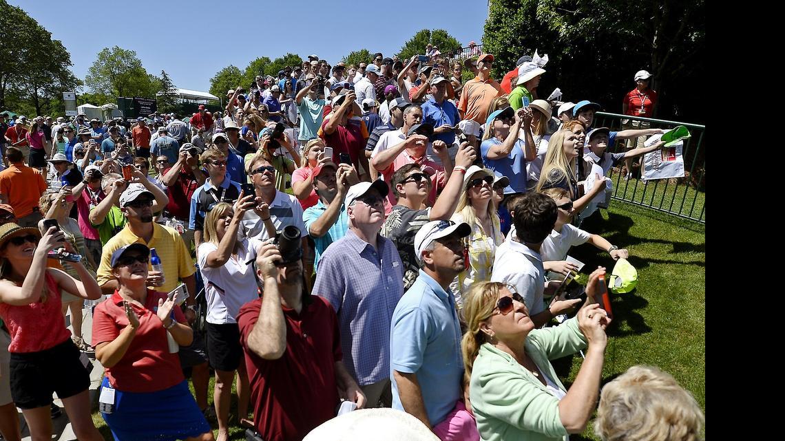 
Fans gather off the 18th green in hopes of seeing and getting an autograph from Phil Mickelson following his round in the Pro-Am at Quail Hollow Club on Wednesday. Charlotte bars, restaurants and hotels are seeing a healthy boost from this week’s unusual confluence of sporting events during an already busy season.
