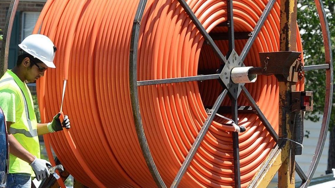 In this 2015 file photo, contractors install fiber optic cable lines for Google Fiber in Highland Creek.