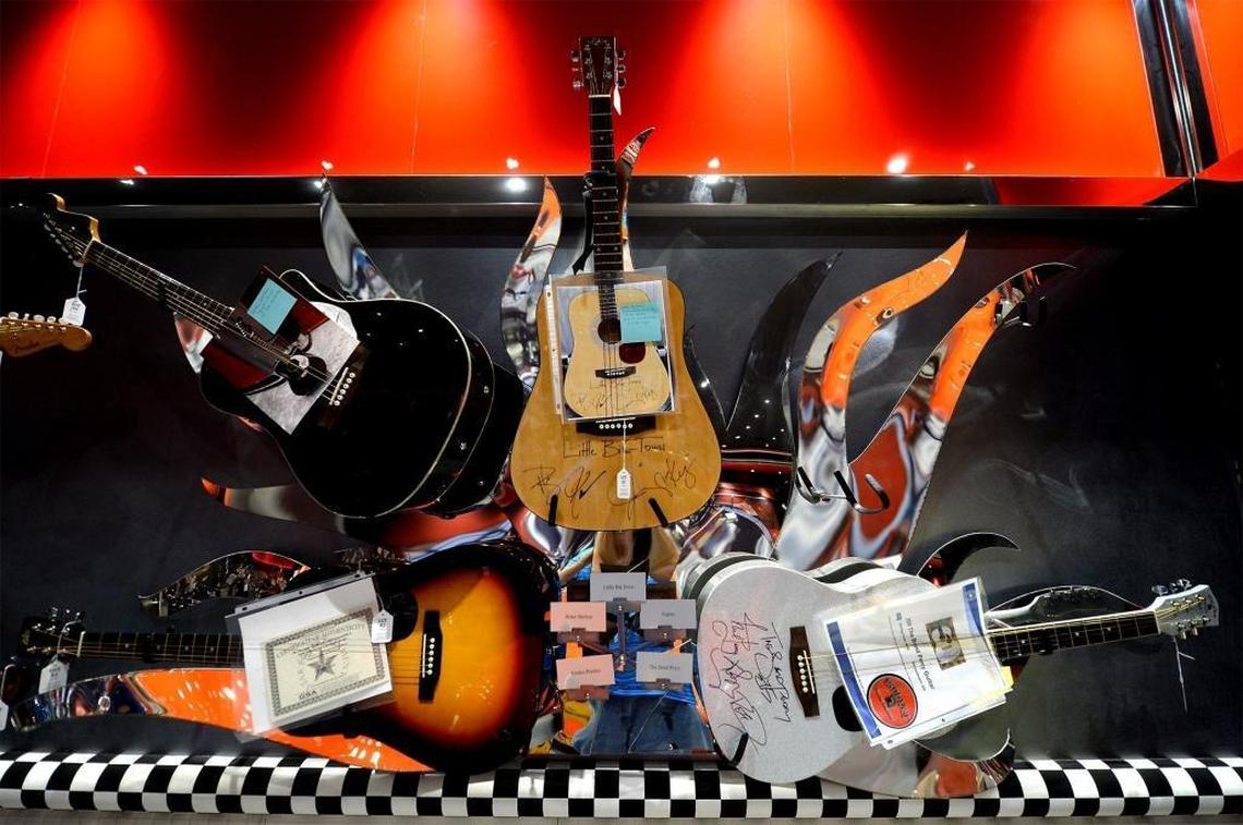 Autographed guitars adorn the walls of Rick Siskey’s garage and man cave.
