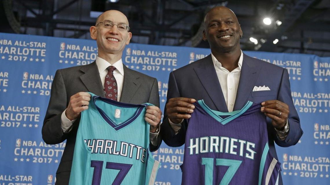 NBA commissioner Adam Silver, left, and Charlotte Hornets owner Michael Jordan, right, pose for a photo during a news conference to announce Charlotte, N.C., as the site of the 2017 NBA All-Star basketball game June 23, 2015.