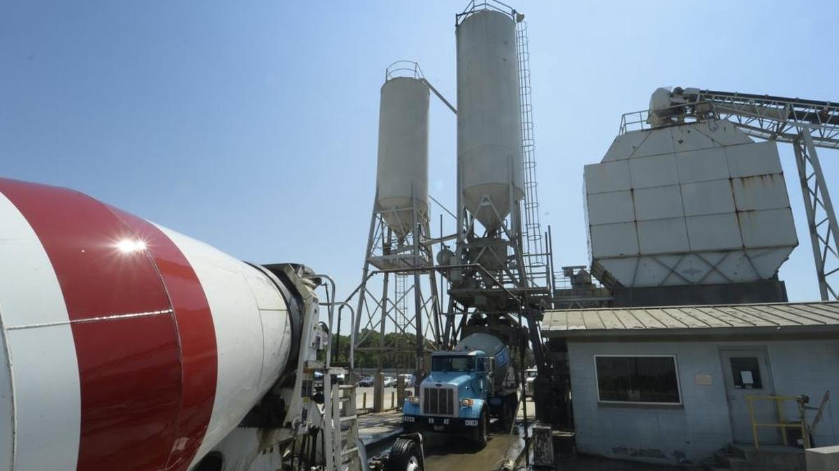 Trucks load up with concrete mix at the Concrete Supply facility on Metromont Rd. in north Charlotte in this file photo. The silo on the left contains fly ash, an ingredient of concrete.