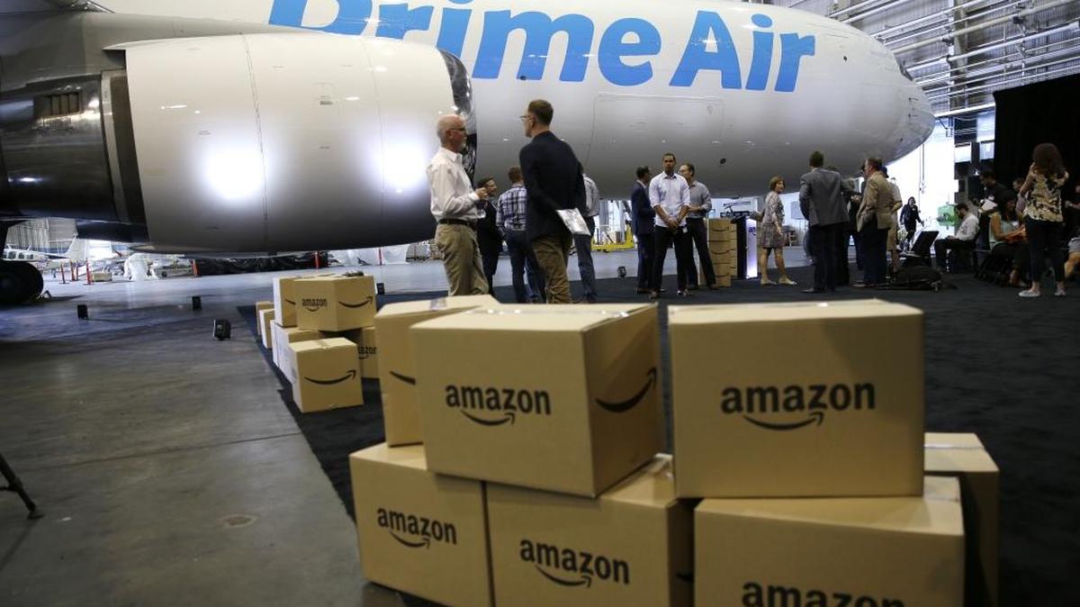 Amazon.com boxes are shown stacked near a Boeing 767 Amazon “Prime Air” cargo plane on display Thursday, Aug. 4, 2016, in a Boeing hangar in Seattle. Amazon unveiled its first branded cargo plane Thursday, one of 40 jetliners that will make up Amazon's own air transportation network of 40 Boeing jets leased from Atlas Air Worldwide Holdings and Air Transport Services Group Inc., which will operate the air cargo network.