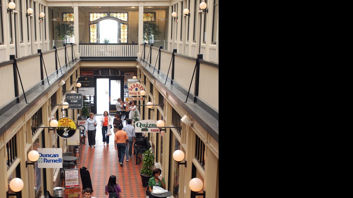 
In this 2009 Observer file photo, customers stroll past restaurants during lunchtime. Businesses in the Latta Arcade and Brevard Court are celebrating the uptown building's 100th anniversary on Wednesday, June 3, 2015. 

