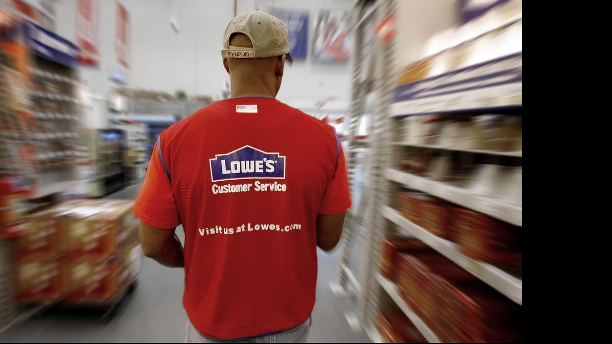 
A Lowe's department manager walks down an isle as he stocks new items on the sales floor of a Lowe's in California. 
