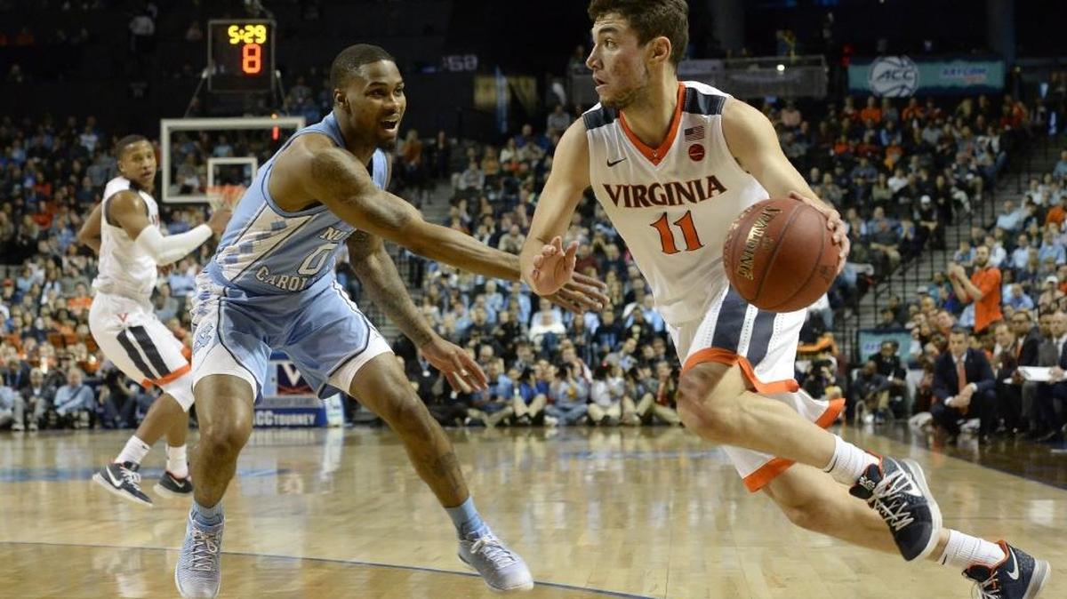 Virginia guard Ty Jerome (11) moves the ball against UNC guard Seventh Woods (0) in the first half. Virginia defeated UNC 71-63 in the championship game of the ACC Tournament at the Barclays Center in Brooklyn, N.Y., on March 10, 2018.