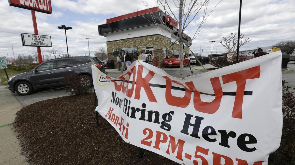 This March 29, 2013 file photo shows a help wanted sign in front of a Cookout restaurant.