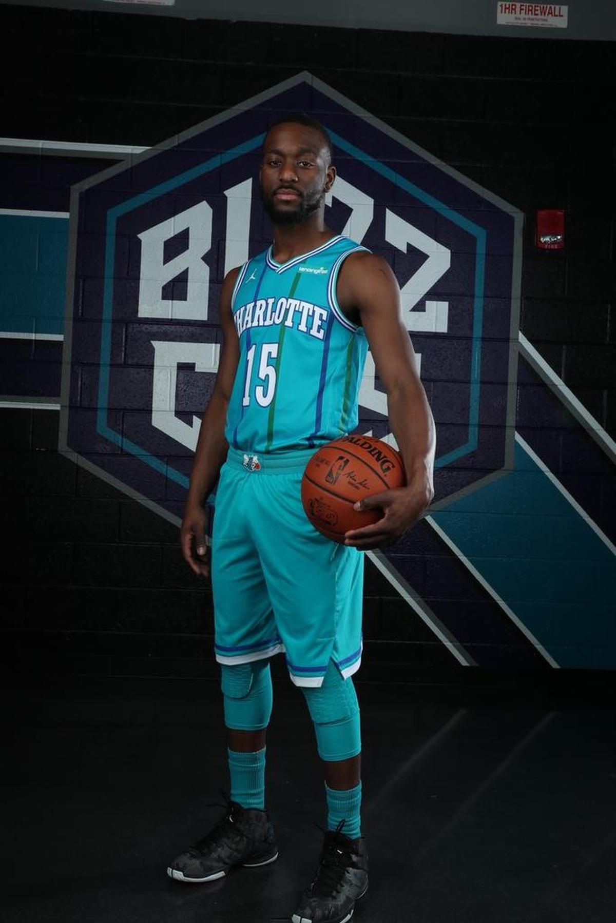 Charlotte Hornets guard Kemba Walker wears a jersey with the logo of the team’s new corporate partner, LendingTree.