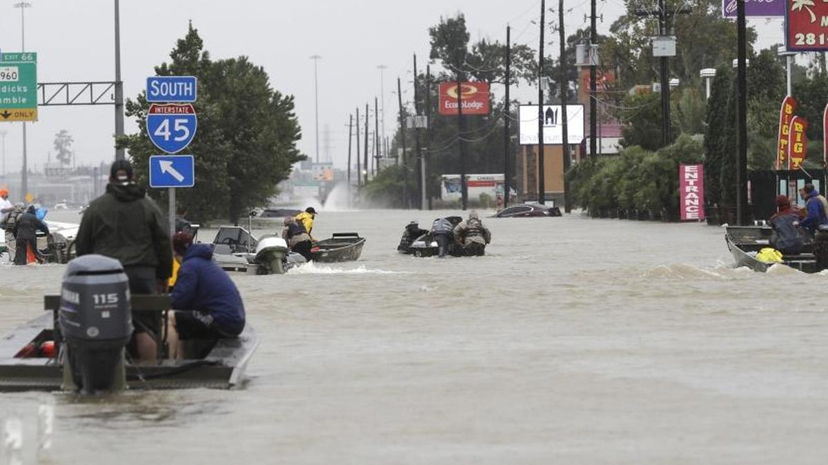 Volunteer rescue boats make their way into a flooded subdivision to rescue stranded residents as floodwaters from Tropical Storm Harvey rise Monday, Aug. 28, 2017, in Spring, Texas.