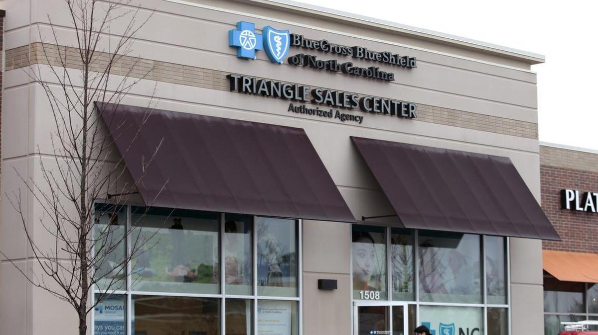 A client enters the Blue Cross Blue Shield of North Carolina Triangle Sales Center in the Village Market Place shopping center in Morrisville.