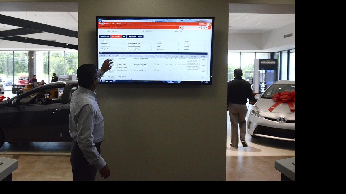 
Sanjay Prakash, Town & Country Toyota general manager, demonstrates how a customer can use various assets in the “Help Center.” Sonic Automotive’s new dealership model aims at being high-tech, efficient and fast. They say the way they use technology can enhance the customer experience and have them out of the door with the car they want within 45 minutes. 
