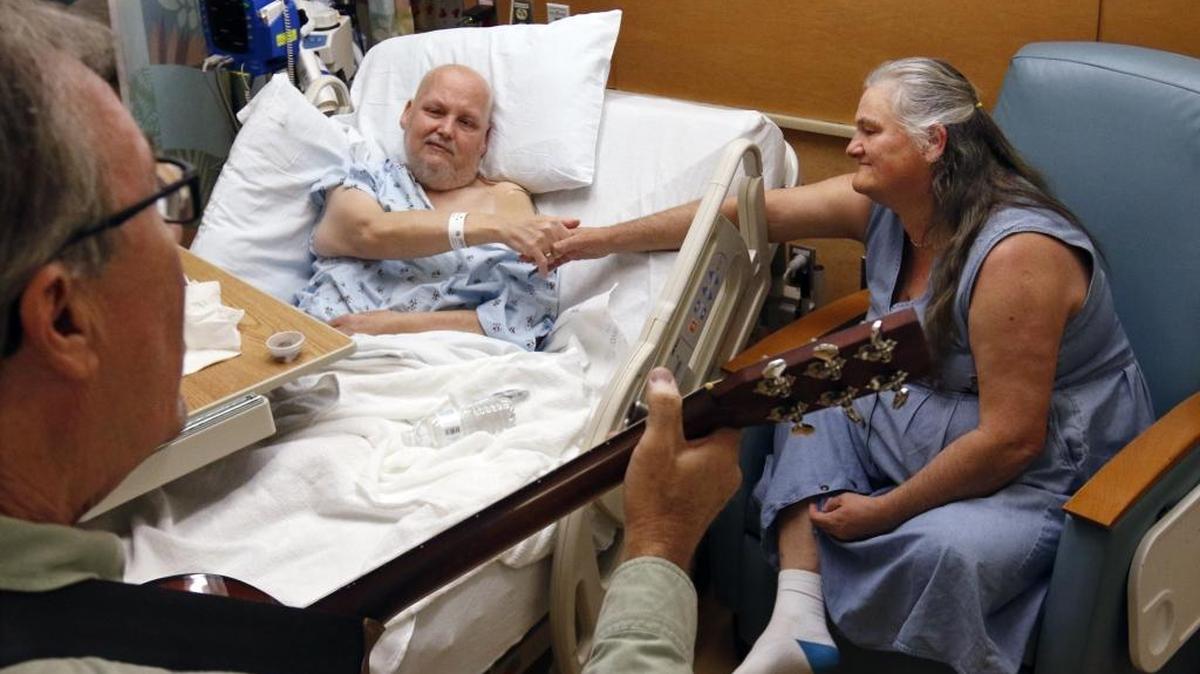 A guitarist plays for a patient at UNC Hospital. Experts say patient costs could rise under the partnership announced between Carolinas HealthCare and UNC Health Care.