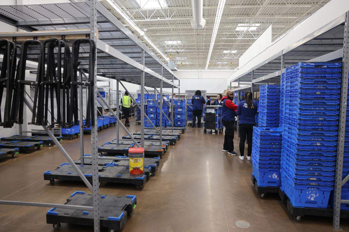 Walmart associates prepare carts to shop for online orders Thursday at the Indian Trail Walmart.