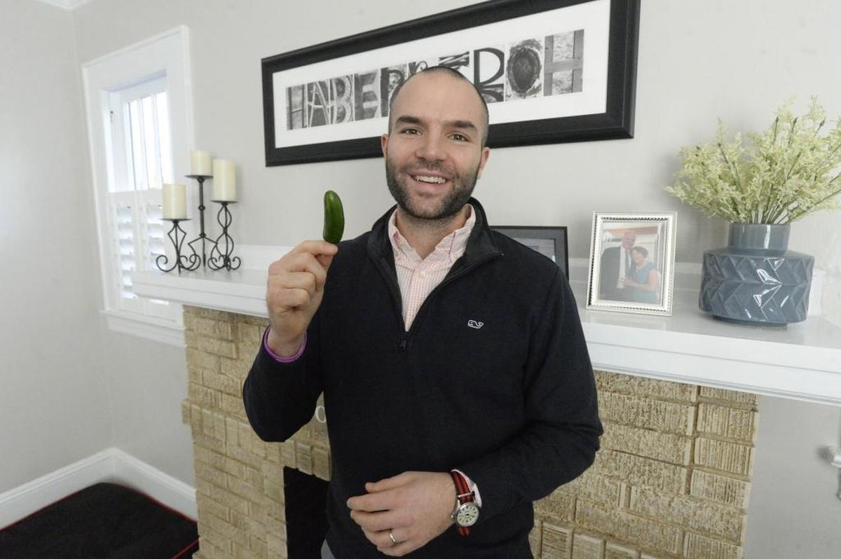 Tom Haberstroh holds up a hot pepper in his Charlotte home on Jan. 23. Haberstroh is a Charlotte-based NBA media personality whose mother, Patty, was diagnosed with ALS in October 2017. Haberstroh and his siblings officially kicked off the ALS Pepper Challenge on Christmas Day.