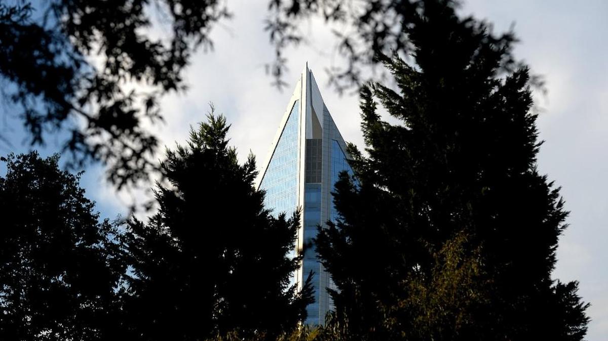 The Duke Energy Center seen through trees in uptown Charlotte.