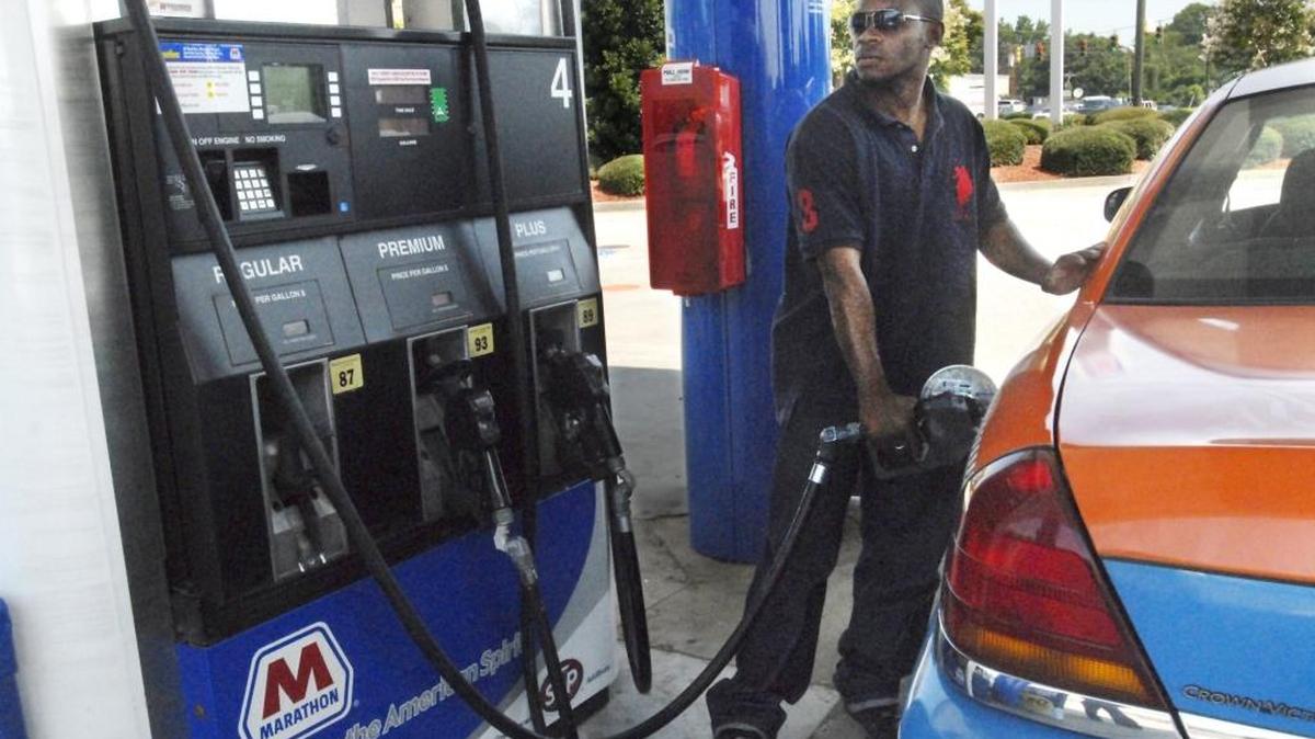 Alyasa Adams pumps gas into his taxi at the Marathon gas station on Independence Boulevard in this July 2011 file photo.