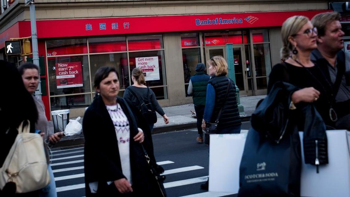 Pedestrians pass in front of a Bank of America branch in New York on Oct. 12, 2016.
