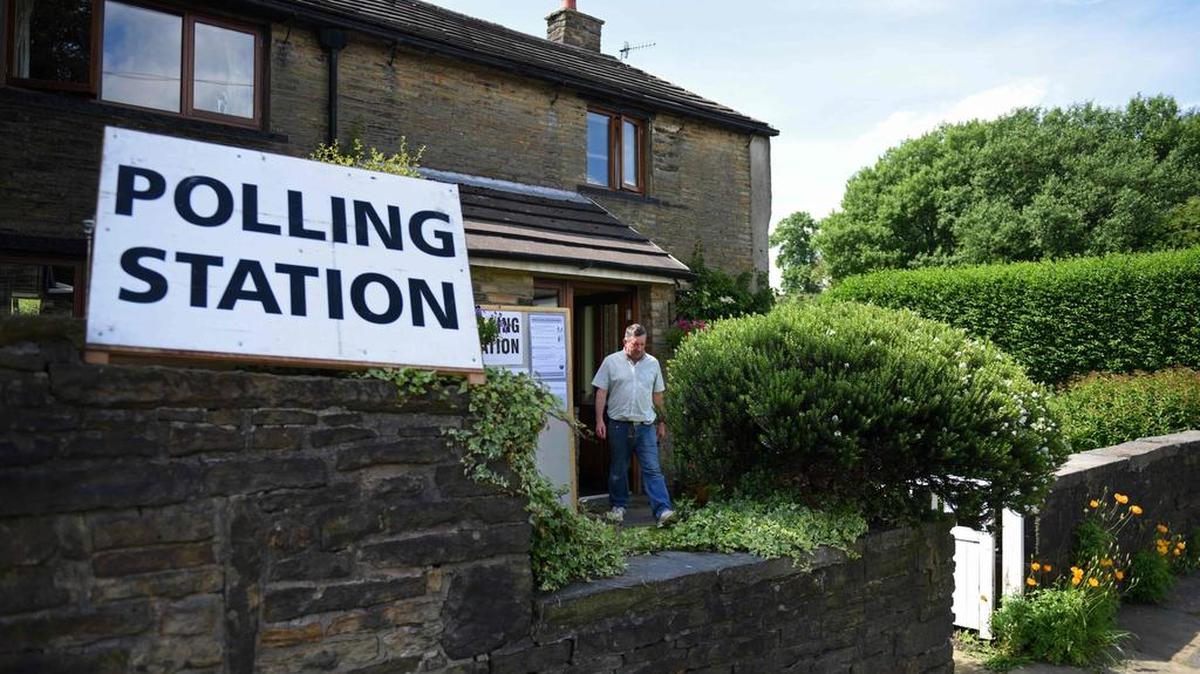A voter leaves afer casting his ballot paper at a polling station set up inisde a residential house in Rochdale, northern England, on June 23, 2016, as Britain holds a referendum to vote on whether to remain in, or to leave the European Union (EU). Millions of Britons began voting Thursday in a bitterly-fought, knife-edge referendum that could tear up the island nation's EU membership and spark the greatest emergency of the bloc's 60-year history.