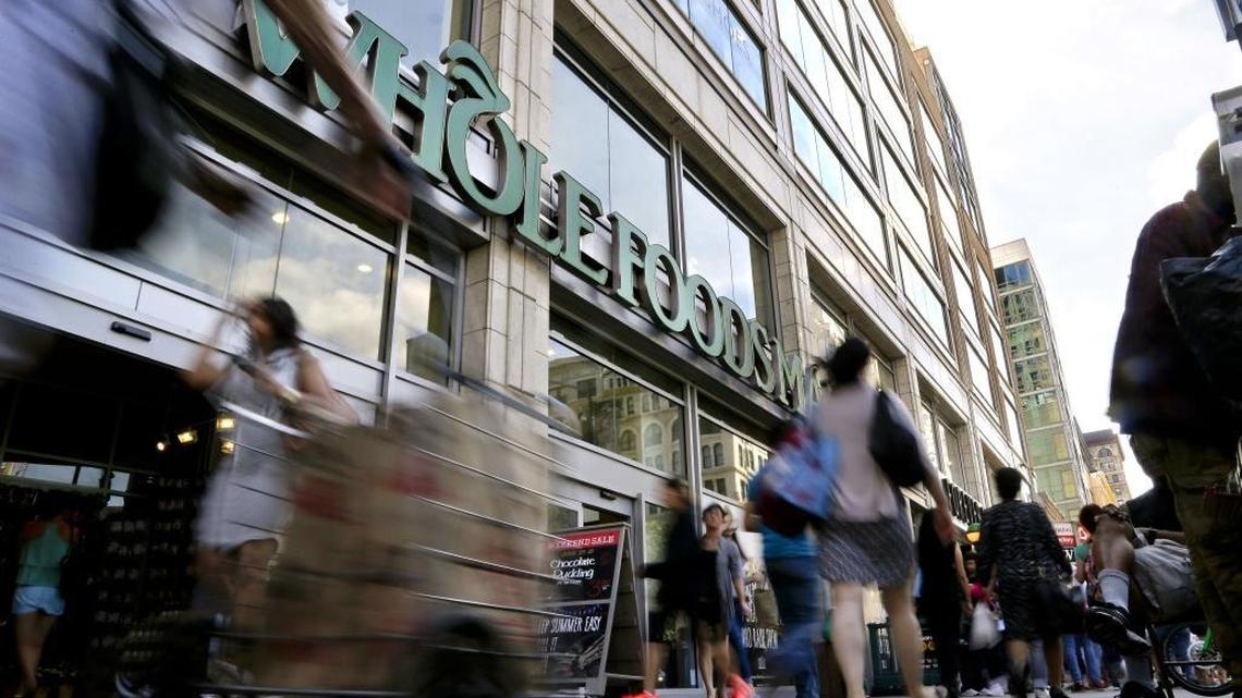 FILE - In this Wednesday, June 24, 2015, file photo, pedestrians pass in front of a Whole Foods Market store in Union Square, in New York.
