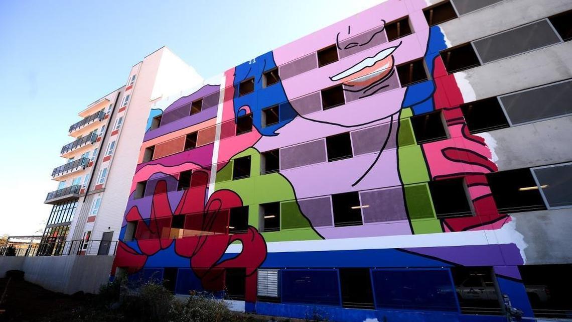 The mural on the back side of the parking garage at the Novel NoDa apartment building is a work in progress as construction continued on the site on Oct. 18, 2017.