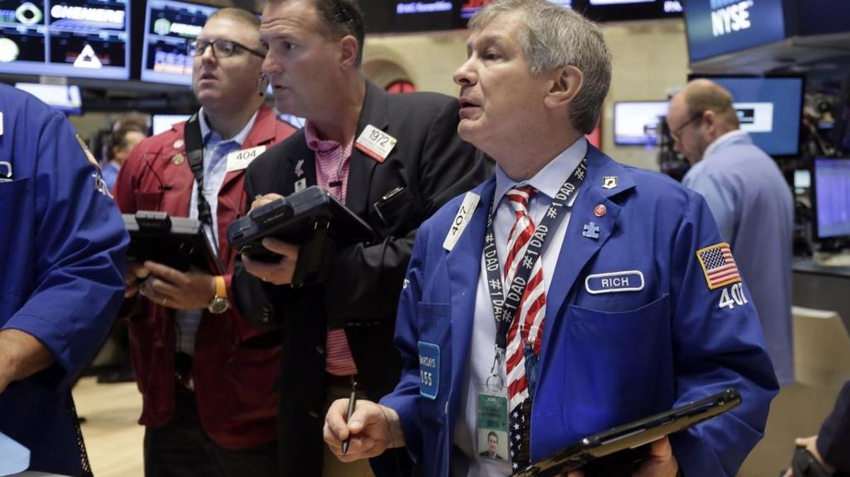 
Traders Ryan Falvey, Jonathan Corpina, and Richard Newman, left to right, work on the floor of the New York Stock Exchange, Friday. U.S. stocks closed sharply lower.

