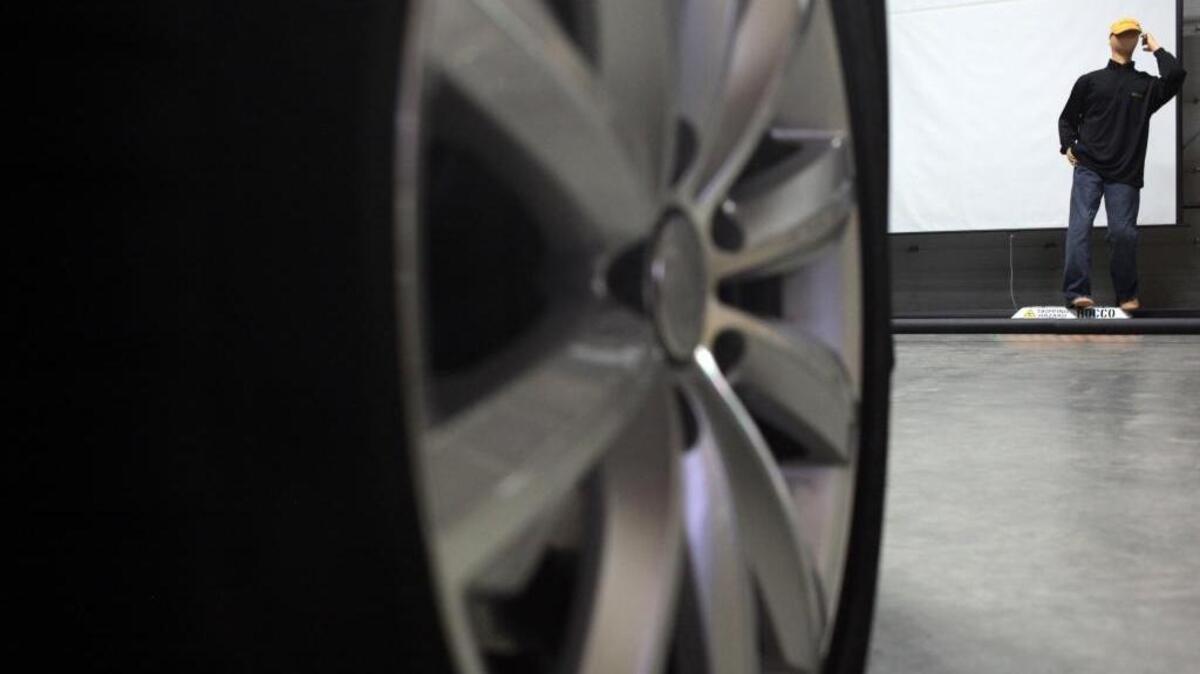 A robot built by the systems engineering team helps with testing of the autonomous car being built by Continental Automotive at the Continental development center in Brimley, Mich.